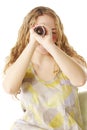 Woman looks through scrolled paper