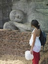 Woman Looks At Sleeping Buddha Statue Royalty Free Stock Photo