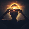 woman looks at a solar eclipse through sunglasses Royalty Free Stock Photo