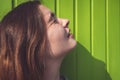 Woman looks at the sun with narrowed eyes