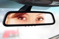 Woman looks to rear-view mirror Royalty Free Stock Photo