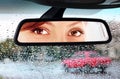 Woman looks to rear-view mirror Royalty Free Stock Photo