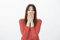 Woman losing speech from amazing surprise made by friends. Studio portrait of surprised happy attractive girlfriend