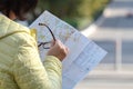 Woman lost hiking, confused looking at map