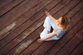 Woman doing yoga on rivers dock Royalty Free Stock Photo