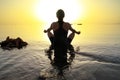 Woman in lotus pose at sunrise Royalty Free Stock Photo
