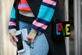 Woman with Love bag with Lego bricks and striped colorful shirt before Antonio Marras fashion show, Milan