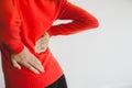 Woman with lower back pain,Female suffering from backache,Copy space and white background,Selective focus hands