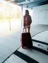 Woman with luggage exit airport parking to terminal