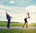 Woman lugging man on the road Royalty Free Stock Photo