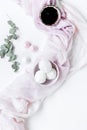 Woman lunch with marsh-mallow and flowers soft light on white table background flat lay