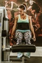 Woman lunging with weights at gym