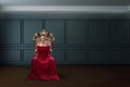 A woman in a luxurious dress sitting on a queen`s throne