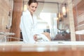 Woman in luxurious hotel bathroom letting water in the bathtub Royalty Free Stock Photo