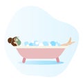 Woman lying in bathtub full of soap foam. Woman taking a bath