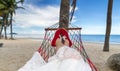 Woman lying in the beach cradle