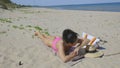 Woman lying on the beach under a bright sun