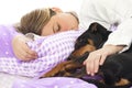 Woman lying in bed with dog Royalty Free Stock Photo