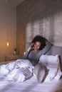 Woman lying in bed having a phone conversation Royalty Free Stock Photo