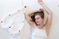 Woman lying on the bed with heart shped towels showing heart gesture Royalty Free Stock Photo
