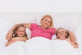 Woman lying in bed with her children Royalty Free Stock Photo