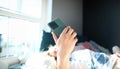 Woman lying bed and looking at smartphone screen Royalty Free Stock Photo