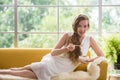 Woman lying on a couch holding a bowl of yogurt Royalty Free Stock Photo