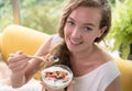 Woman lying on a couch holding a bowl of yogurt Royalty Free Stock Photo