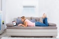 Woman Lying On Couch Using Laptop For Shopping Online