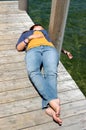 Woman lying on the docklake lakeside. Royalty Free Stock Photo