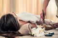Woman lying down during Asian anti-aging treatment