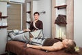 A woman lying down doing pressotherapy treatment.