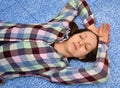 Woman lying down on her back in bed and napping or sleeping