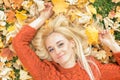 Woman lying down on yellow leaves Royalty Free Stock Photo