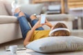 Woman lying on the floor and listening to music Royalty Free Stock Photo