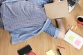 woman lying on floor with mobile phone, notebook and laptop Royalty Free Stock Photo