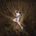 Woman is lying in golden field of wheat Royalty Free Stock Photo
