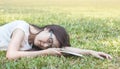 Closeup woman lying grass field after she tired for reading in the afternoon Royalty Free Stock Photo