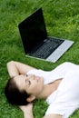 Woman Lying On Grass With Laptop
