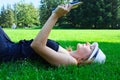 Woman lying in grass reading a book Royalty Free Stock Photo