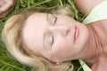 Woman lying in grass sleeping