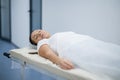 A woman lying on a gurney befre diagnostic procedure