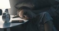 Woman lying her head on the bedside table and sleeping Royalty Free Stock Photo