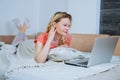 Woman is lying on her sofa at home and shopping online Royalty Free Stock Photo