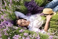 Woman lying in lavender field on summer day Royalty Free Stock Photo
