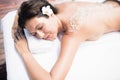 Woman lying on massage table with salt scrub on back Royalty Free Stock Photo