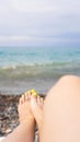 Woman lying near water. Woman legs near blue sea