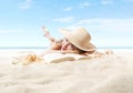 Woman lying on sand beach with book, sunbathing wearing sun straw hat. Concept of summer beach holiday and vacation travel. Sea Royalty Free Stock Photo