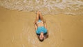 Woman lying on shallow water sea. Happy slightly tipsy woman enj