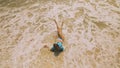 Woman lying on shallow water sea. Happy slightly tipsy woman enj